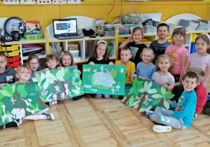 Dzieci prezentują wspólną pracę plastyczną zatytułowaną Dżungla